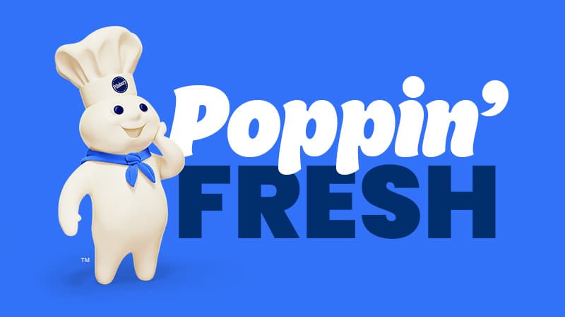 Pillsbury Doughboy looking delighted, standing next to the words “Poppin’ Fresh” in big, bold letters.
