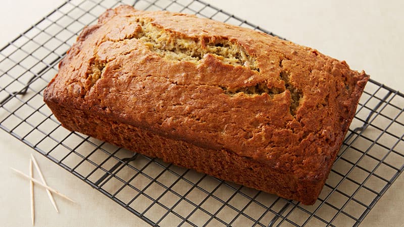 A loaf of Banana Bread on a cooling rack