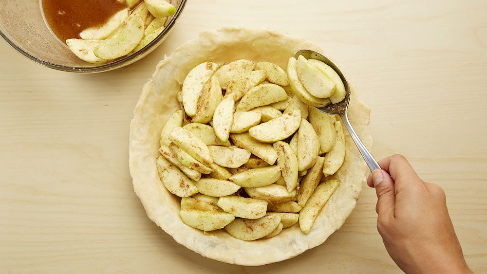 Spoon the pie filling into the crust-lined pie plate.